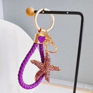 Starfish keychain with pink rhinestones, purple leather loop and gold heart charm