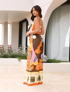 Detail of high-waist wide-leg pants with vibrant orange and brown geometric patterns