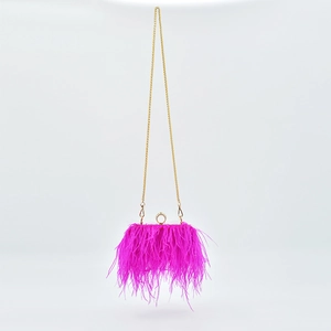 Detail of rose red feather evening bag with gold ring clasp and detachable chain strap