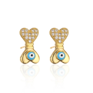 Macro detail of 18K gold-plated devil's eye stud earrings with heart-shaped zircon inlay