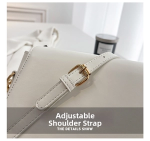 Close-up of the adjustable strap and golden metal buckle on a white PU leather bag