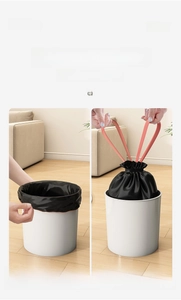 Detail of thick drawstring garbage bag with orange handle in a modern white waste bin