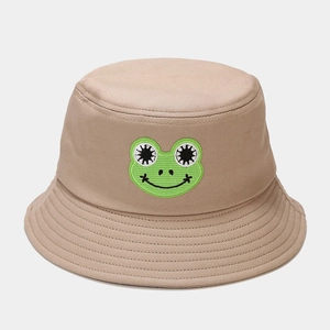 Close-up of cute green frog embroidery and reinforced stitching on a khaki bucket hat