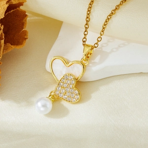 Golden heart pendant necklace with shimmering zircon, mother of pearl and a round pearl