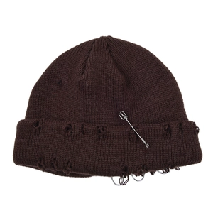 Detail showing the distressed texture and metal ring accessories on the brown beanie.