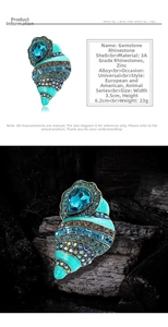 Macro shot of conch brooch showing 3A rhinestones and turquoise enamel waves detail