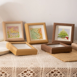 Square 4-inch solid wood picture frames with 3D oil pastel art on white lace tablecloth