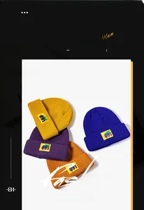 Detail of four colorful knit beanies with decorative patches for winter outdoor warmth