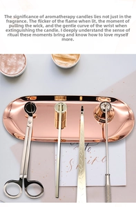 Macro detail of rose gold stainless steel candle snuffer and wick trimmer tool set