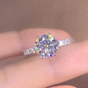 Elegant six-prong crystal wedding ring with shimmering side stones on a silver-tone band