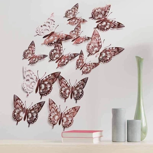 Detailed view of 3D rose gold hollow butterfly wall stickers in a home decor scene