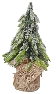 Close-up of mini snow-flocked Christmas tree with rustic burlap base for tabletop decor