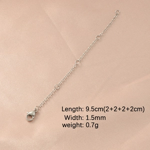 Detail of silver stainless steel extender chain with lobster clasp on pink silk