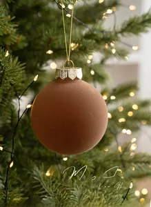 Detailed view of 8cm brown flocked Christmas ball with snowflake embossed metal cap