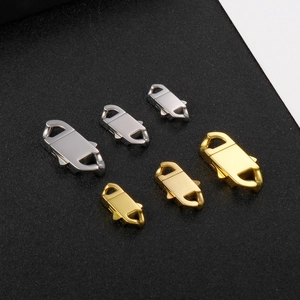Macro view of stainless steel lobster clasps in gold and silver colors and various sizes
