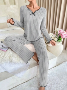 Detail of grey ribbed lounge set with black lettuce edge trim and soft knit texture