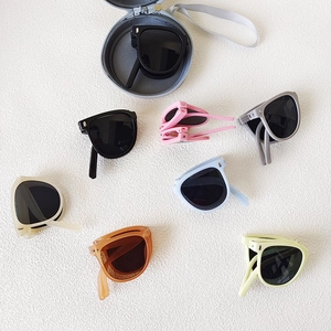 Foldable kids sunglasses in assorted colors with portable round zipper storage case