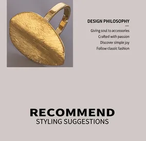 Detail of gold open ring featuring large oval matte brushed metal surface texture