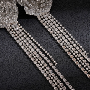 Macro shot of silver crystal flower earrings with long shimmering diamond tassels