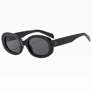 Detail view of oval sunglasses with glossy black frame and silver triple rivet accents
