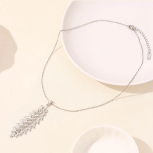 Close-up of silver leaf pendant with fine textures on stainless steel chain and clasp