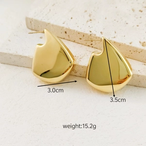 Detailed size view of 18K gold plated hollow irregular ear studs on stone platform