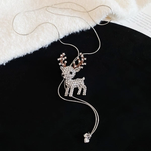 Detail of silver reindeer necklace with crystal rhinestones and tiny heart pendant charm