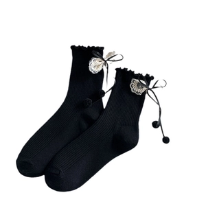 Lolita style black knee-high socks featuring white lace trim and silk bow with pom-poms