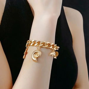 Gold chunky chain bracelet featuring dolphin, conch and starfish charms for women