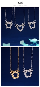 Detail of 18K gold plated heart and star pendants featuring sparkling zircon inlay details