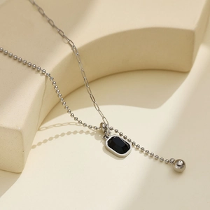 Minimalist silver chain necklace with black rectangular pendant and dual chain design