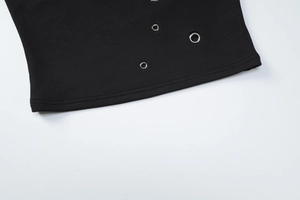 Detailed macro view of black ribbed knit fabric with silver metal eyelet grommets