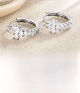 Detailed view of silver cross hoop earrings with 12mm inner diameter and cubic zirconia stones