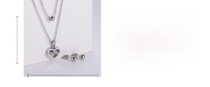 Detail of silver heart necklace and earrings set with dimensions and mama engraving