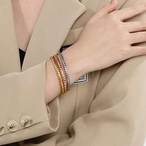 Three-piece stackable textured metal bangles in gold, rose gold and silver finishes