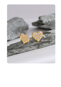 Close-up of 14K gold plated heart stud earrings with sparkling pave zircon settings