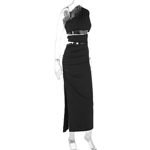 Detail of side ruching, waist cutouts and high slit on a black bodycon dress