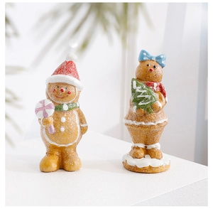 Close-up of resin gingerbread man figurines with glitter coating and festive details
