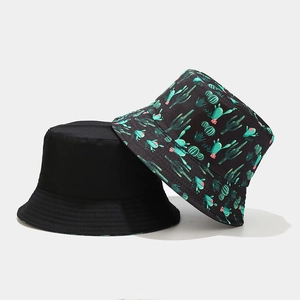 Reversible bucket hat featuring solid black and cactus print design with stitched brim