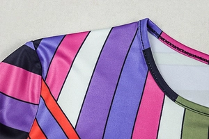 Detail of the crew neck and shoulder stitching on a colorful striped bodycon dress