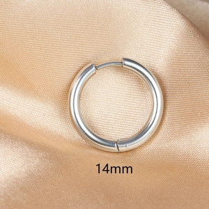 Macro detail of 14mm silver stainless steel hoop earring on luxury champagne silk fabric