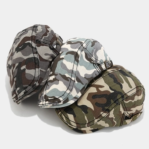 Detailed stack of vintage camouflage newsboy caps with side metal adjustable buckles