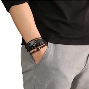 Close-up of multilayer men's leather bracelet set with tree of life charm and beads