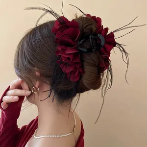 Elegant large deep red layered fabric flower hair claw with black feather accents