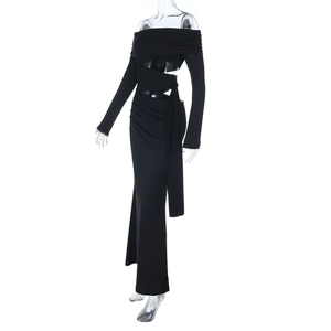 Detail of black off-shoulder maxi dress featuring waist cut-out and mesh sleeve patchwork
