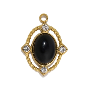 Detail of vintage oval black onyx pendant with gold rope edge and small crystals