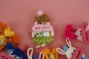 Macro detail of handmade crochet sausage lip key case with high-quality yarn texture