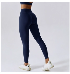 Detail view of high-waisted dark blue yoga leggings with ruched butt lift stitching