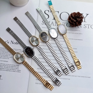 Detailed display of five small oval quartz watches with flexible metal link bracelets