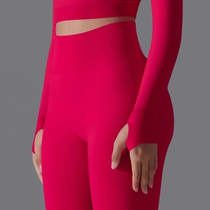 Detailed shot of seamless red yoga set showing high-waist ribbing and thumbhole sleeves